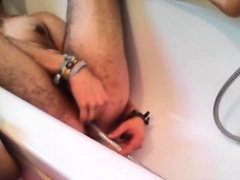 Bi-guy using shower head, squirting water, enema